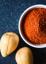 A close up of avocado seeds and seed powder in a cup