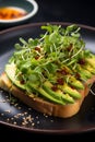 Close-up avocado toast, garnished with microgreens and a touch of chili