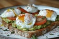 Close up of avocado toast with poached eggs, tomatoes, and fines herbes Royalty Free Stock Photo