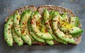 A close-up of avocado toast seasoned with red pepper flakes and sesame seeds, a delicious and healthful delight. The