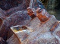 close up of an axle bolts and wheel on old rusted abandoned industrial machinery