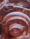 a close up of an axle and pieces on old rusted abandoned industrial machinery