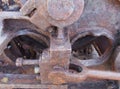 close up of an axle and rods on old rusted abandoned industrial machinery