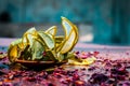 Close up of Ayurvedic face pack`s ingredients i.e cucumber and Aloe Vera gel with rose petals on a wooden surface in dark Gothic