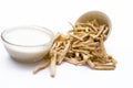 Close up of Ayurvedic herb Satavari or kurilo or Asparagus racemosus isolated on white in a glass bowl with milk.