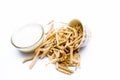 Close up of ayurvedic herb satavari or kurilo in a glass bowl with milk and its powder isolated on white.