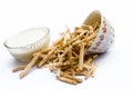 Close up of Ayurvedic herb Satavari or kurilo or Asparagus racemosus isolated on white in a glass bowl with milk.