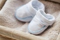 Close up of baby bootees for newborn boy in basket Royalty Free Stock Photo