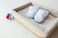 Close up of baby bootees for newborn boy in basket Royalty Free Stock Photo