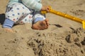 Close up baby boy playing with sand toys at the beach. Royalty Free Stock Photo
