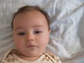 Close up of baby boy's face looking at camera with cute grin Royalty Free Stock Photo