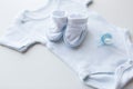 Close up of baby boys clothes for newborn on table Royalty Free Stock Photo