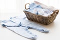 Close up of baby clothes for newborn boy in basket Royalty Free Stock Photo