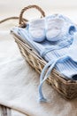Close up of baby clothes for newborn boy in basket Royalty Free Stock Photo