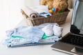 Close up of baby clothes, toys and laptop Royalty Free Stock Photo