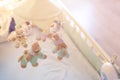 Close-up baby crib with musical animal mobile at nursery room. Hanged developing toy with plush fluffy animals. Happy parenting an Royalty Free Stock Photo