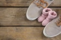 Close up of baby and fathers shoes