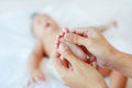 Close-up baby foot massage on the bed Royalty Free Stock Photo