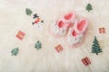 Close up Baby girl knitted shoes on white blanket background.Merry christmas and happy new year greeting card with copy-space.