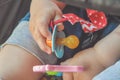 A close up of a baby hand holding a pacifier and a toy Royalty Free Stock Photo