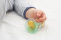 Close up of baby little hand with a pacifier dummy Royalty Free Stock Photo