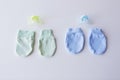 Close up of baby mittens and soothers for twins