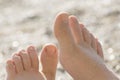 Close-up of baby`s feet covered with sand. Relax on the sea beach Royalty Free Stock Photo