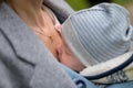 Close up of a baby sleeping in a baby carrier, in an extraordinary closeness to his mother Royalty Free Stock Photo