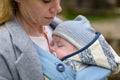 Close up of a baby sleeping in a baby carrier on his mother's chest or cleavage, in an exceptionally intimate closeness Royalty Free Stock Photo