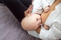 Close-up of a baby sucking on his mother`s breast. Breast-feeding Royalty Free Stock Photo