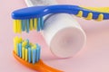 Close-up of baby toothbrushes and toothpaste on color background