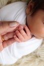 Photo of Newborn baby after birth tightly holding parents finger on white background Royalty Free Stock Photo