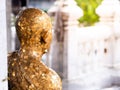 Close up back of the Buddha statue that covered with gold leaf, Thailand. Royalty Free Stock Photo