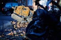 Close up of back of burnt out moped on street of London on sunny day with winter