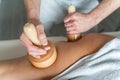 Close up on back of the leg of unknown woman having madero therapy massage anti-cellulite treatment by professional therapist Royalty Free Stock Photo