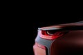 Close-up back rearlight with LED xenon light of brown sport modern car on black colour background Royalty Free Stock Photo