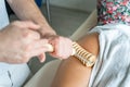 Close up on back of unknown woman having madero therapy massage anti-cellulite treatment by professional therapist holding wooden Royalty Free Stock Photo