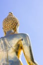 close-up back view big Buddha statue in thailand on blue sky background Royalty Free Stock Photo