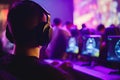 Close-up back view of gamer boy with headphones in a esports competition.Neon led lights background.Streamer concept