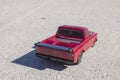 Close up back view of radio-controlled Chevrolet vintage car model isolated on asphalt.