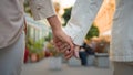 Close up back view of unrecognizable romantic senior elderly couple wife husband holding hands while walking together Royalty Free Stock Photo