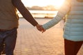 Close up back view of young loving couple holding hands. Parents with baby pram in autumn park. Love, parenthood, family, season a Royalty Free Stock Photo