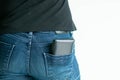 Close-up back of woman in black T-shirt and jeans standing comfortably; with money wallet poke off from jeans pocket