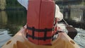 Close up back young adult woman paddling kayaking canoe on a lake Royalty Free Stock Photo