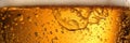 Close up background of beer with bubbles in glass. Pouring beer with bubble froth in glass for background on front view wave curve