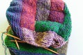 Close-up background image of a variegated knitted blanket with a colorful graphic design
