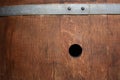 Close-up and background of an old wine barrel with signs of wear and an open hole in the barrel Royalty Free Stock Photo