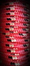 Close-up background of red and black diamond braided rope with space for copy