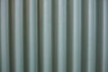 Filled frame close up background wallpaper shot of a galvanized green metal sheet wall with vertical lines and black shadows Royalty Free Stock Photo