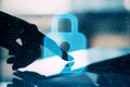 Close up of backlit female hand pointing at tablet with abstract glowing padlock interface on blurry outdoor background. Safety,